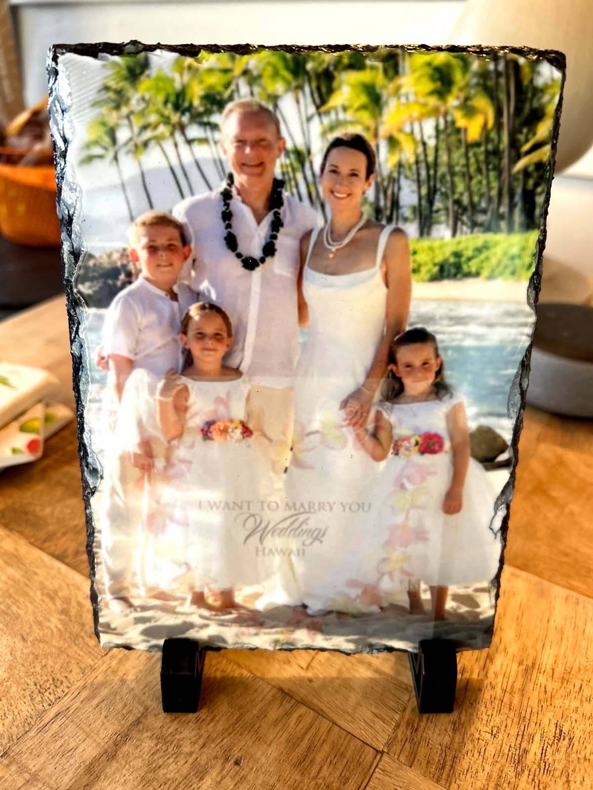 Beach wedding family portrait printed on a natural-edge slate on a display stand